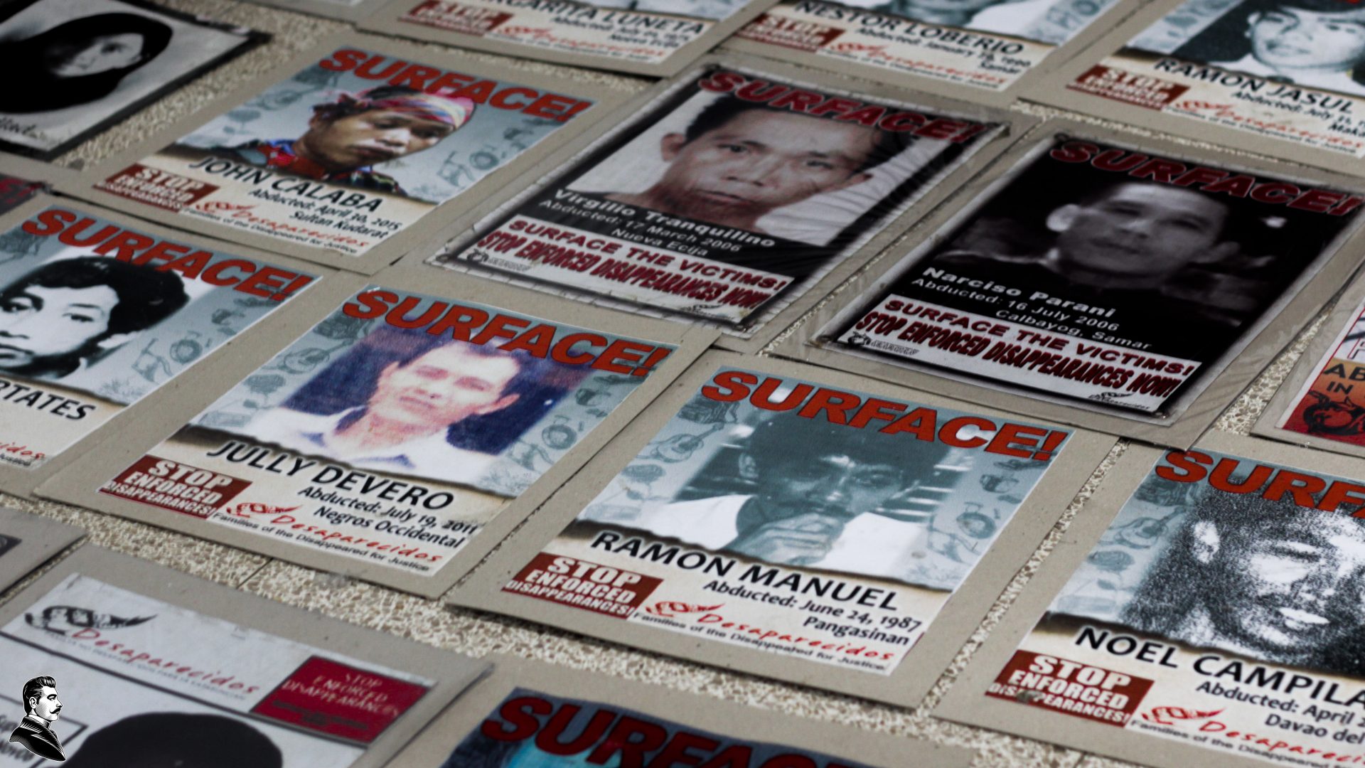 Photos calling for the surfacing of disappeared political activists line the floor of the UP CMC Auditorium during the launching of the UPRISE network against fascism and dictatorship. Photo Raevien Pintang