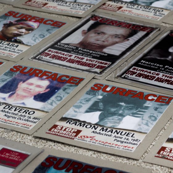 Photos calling for the surfacing of disappeared political activists line the floor of the UP CMC Auditorium during the launching of the UPRISE network against fascism and dictatorship. Photo Raevien Pintang