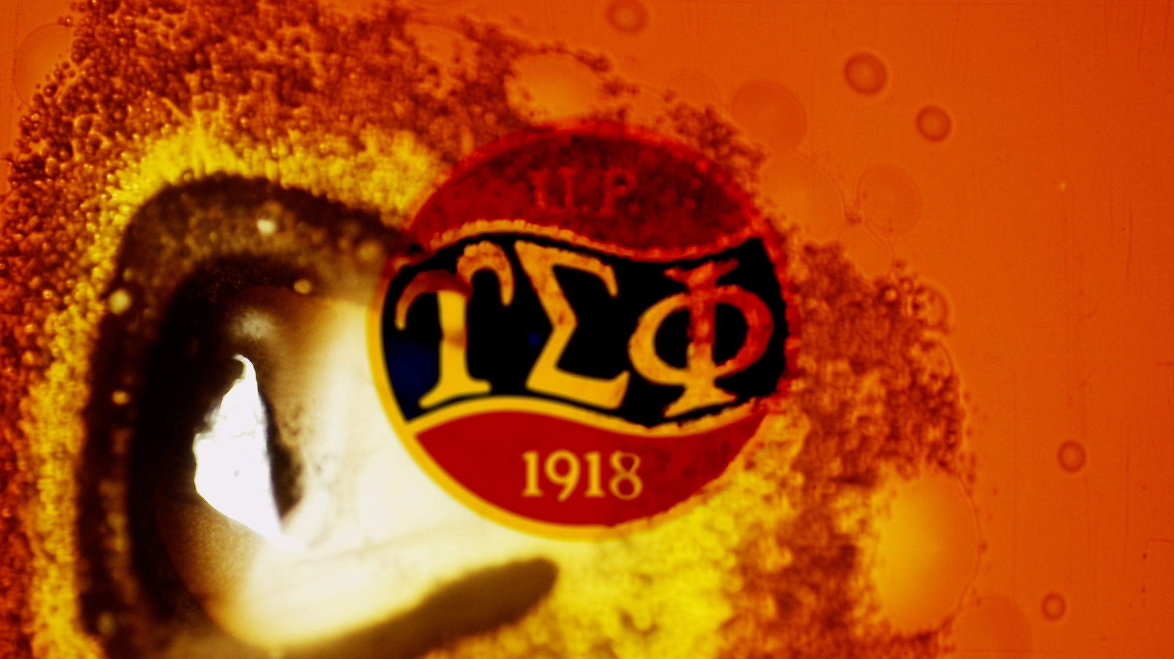Upsilon Sigma Phi logo burned in a celluloid-like effect